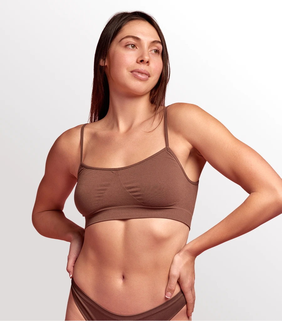 Woman with sculpted abdominal and flank contours in three-quarter pose