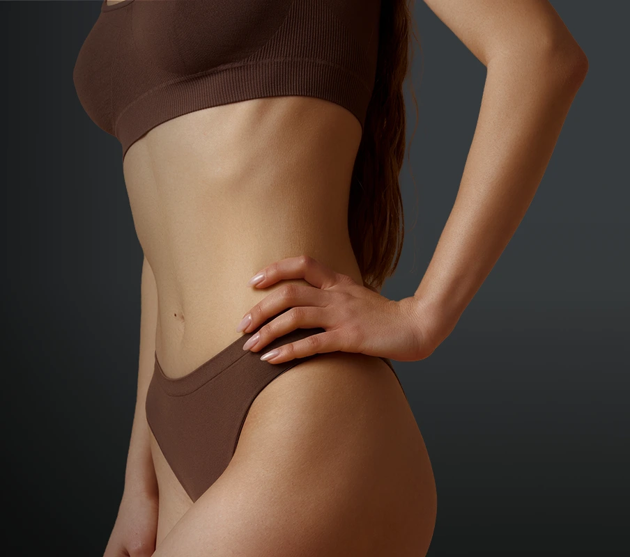 Woman displaying torso and flanks from side angle