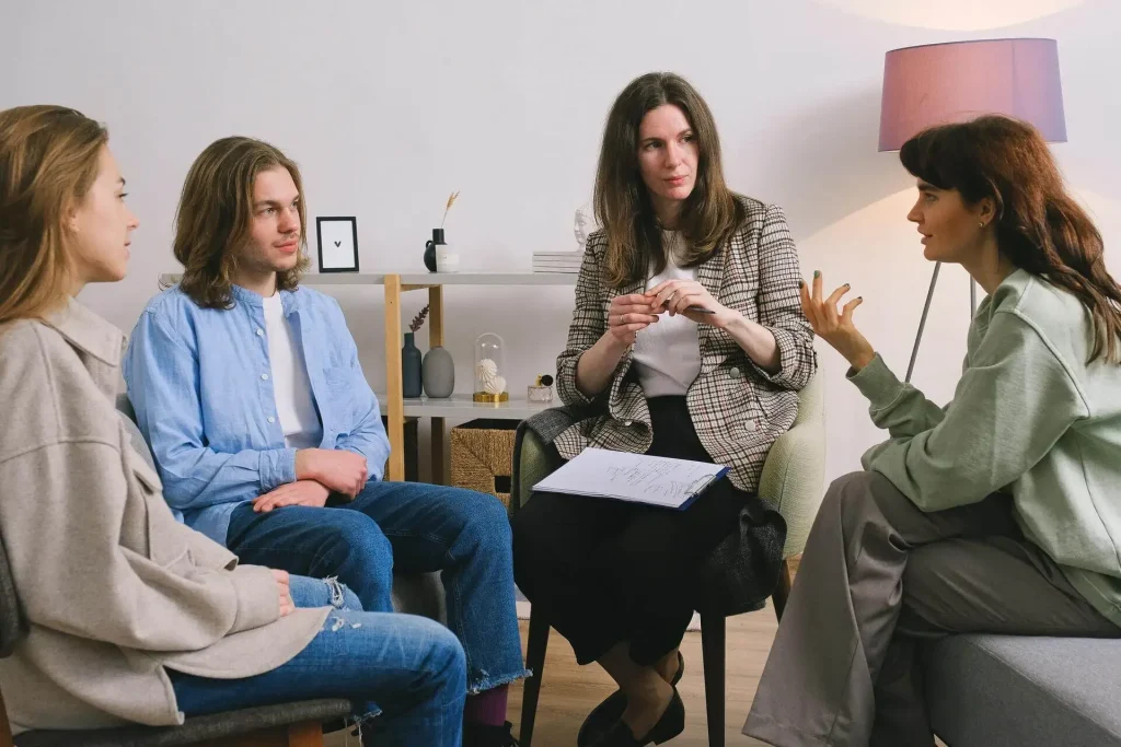 Licensed therapist leading a small group therapy session for addiction recovery
