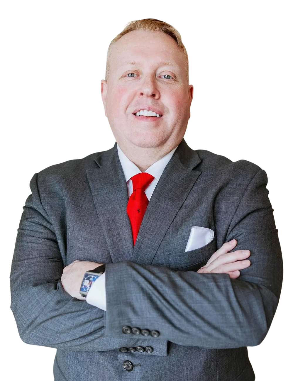 Man in gray suit with red tie and arms crossed, smiling at camera