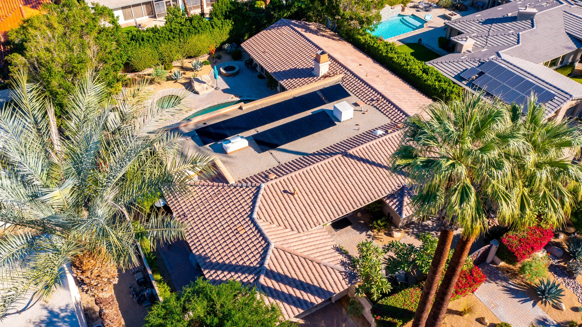 Aerial view of a Coachella Valley home with rooftop solar panels installed by Sunlogix