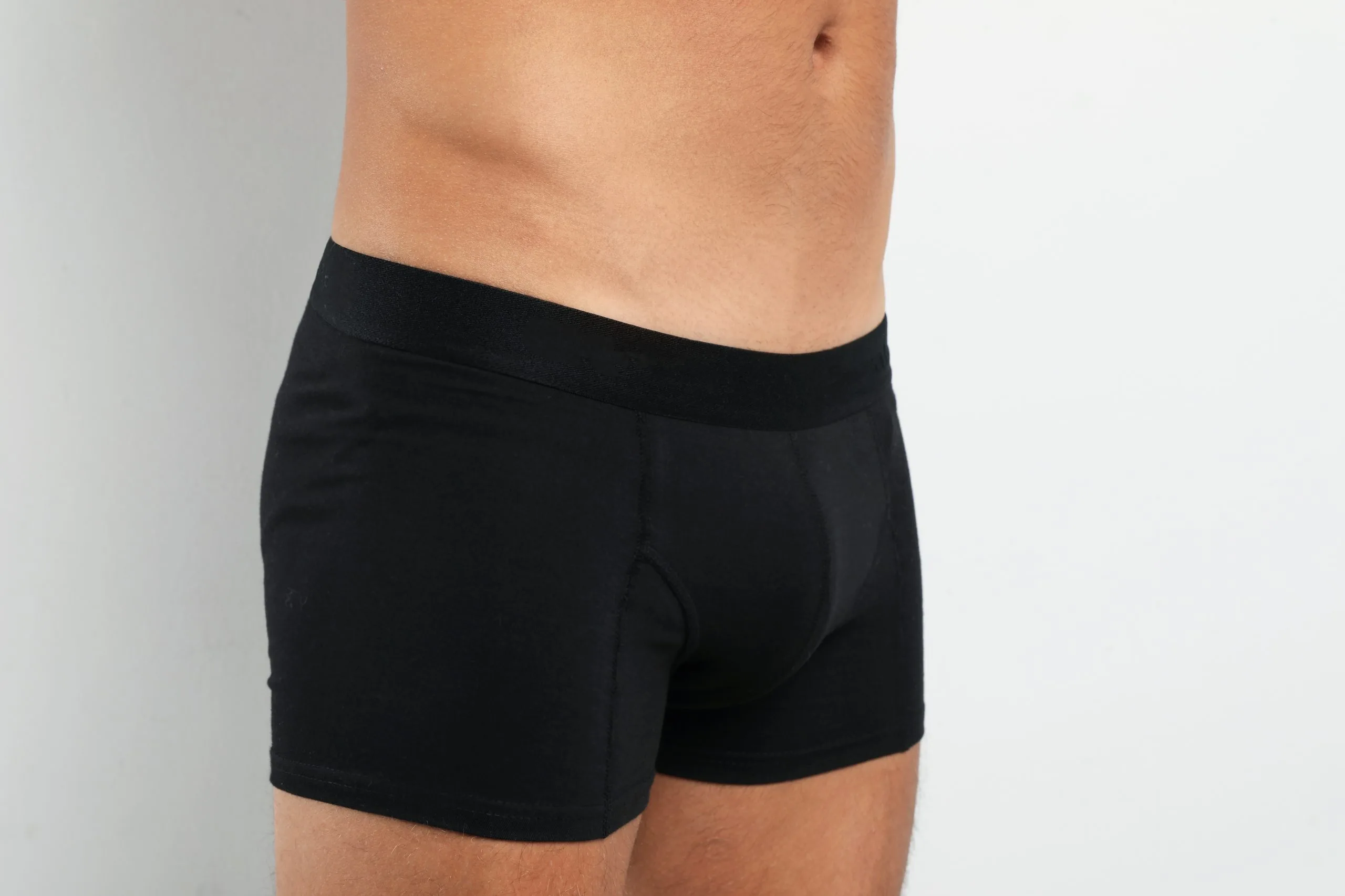 Man wearing black underwear against white background