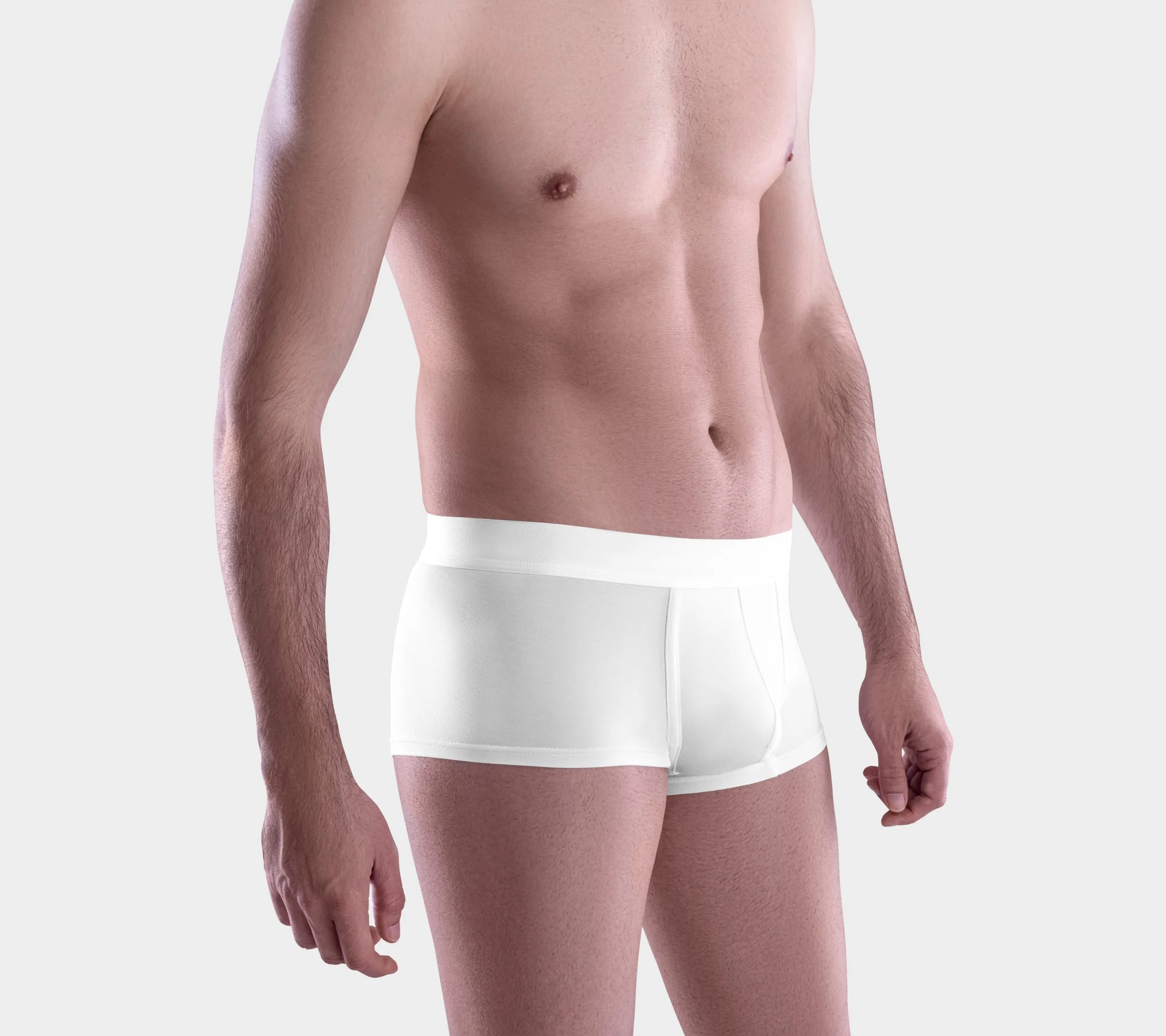 Man wearing white brief underpants against neutral background