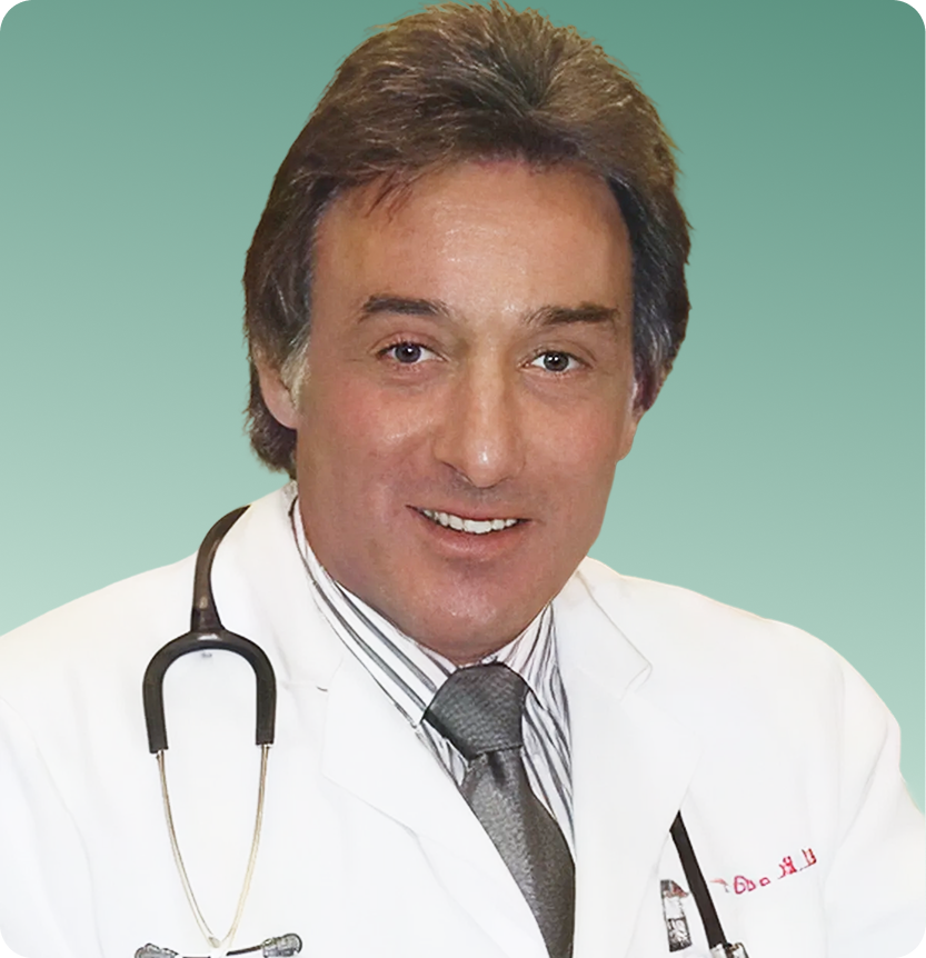 Allergist in white coat with stethoscope smiling at camera against teal background