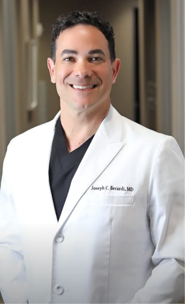 Joseph C. Berardi, MD in white lab coat over black shirt