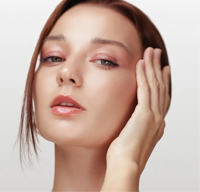 Woman with defined jawline touching her face, demonstrating facial contours