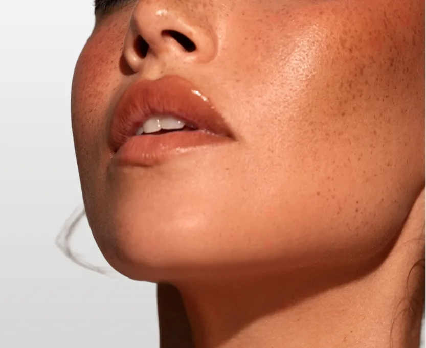 Close-up profile view of a person's jawline, chin, and lower face