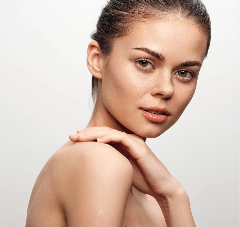 Woman with hand on shoulder looking away, demonstrating smooth upper back and neck area