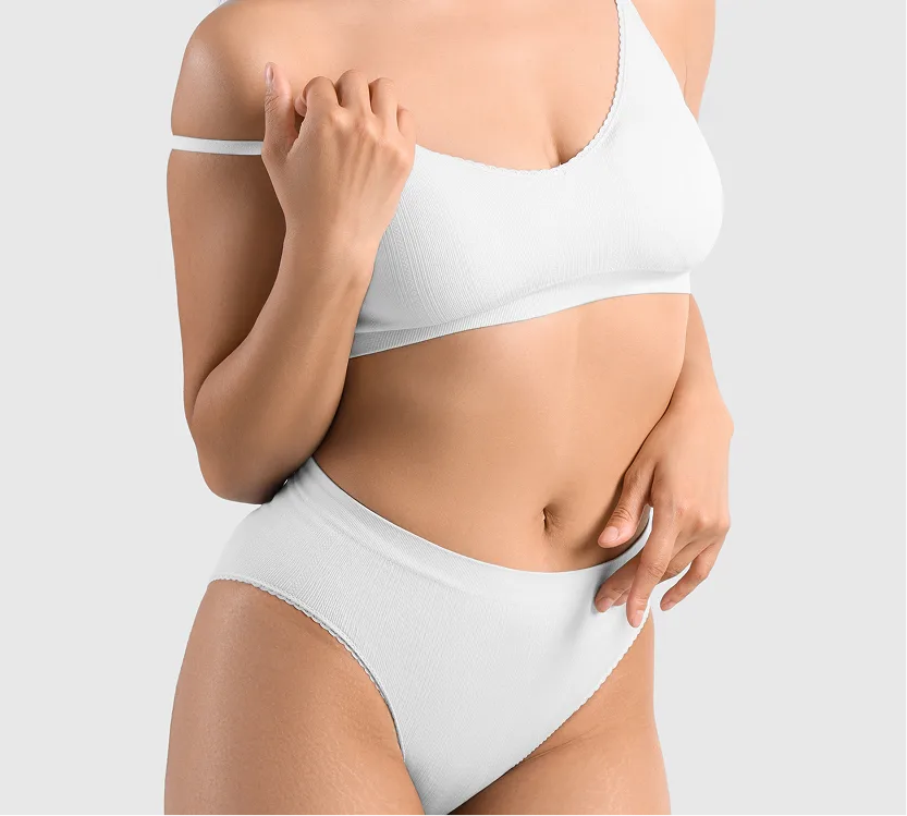 Woman pinching excess skin on upper arm and abdomen, demonstrating body area concerns
