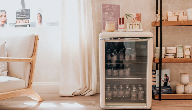 Skincare product display cabinet with glass doors, wooden shelving, and treatment product bottles