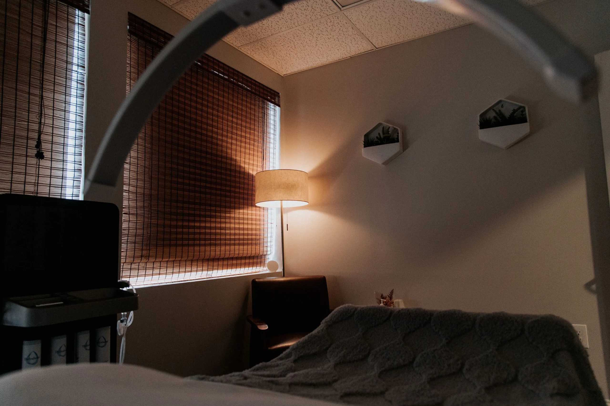 LED light therapy treatment room with warm-toned panel lighting and comfortable seating at Thrive Med Spa + Wellness Portsmouth