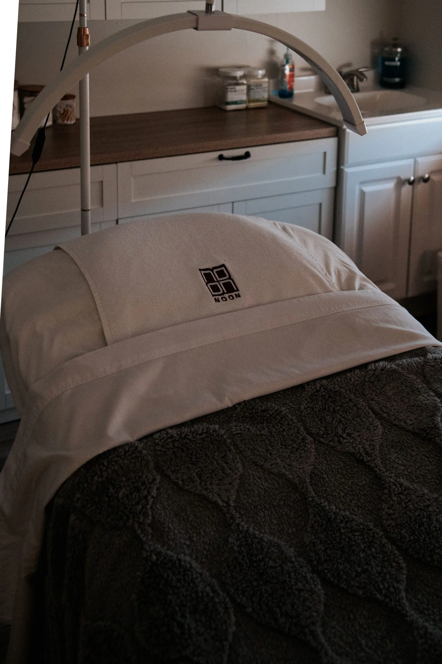 Biorepeel treatment bed with overhead lamp in a clinical treatment room at Thrive Med Spa