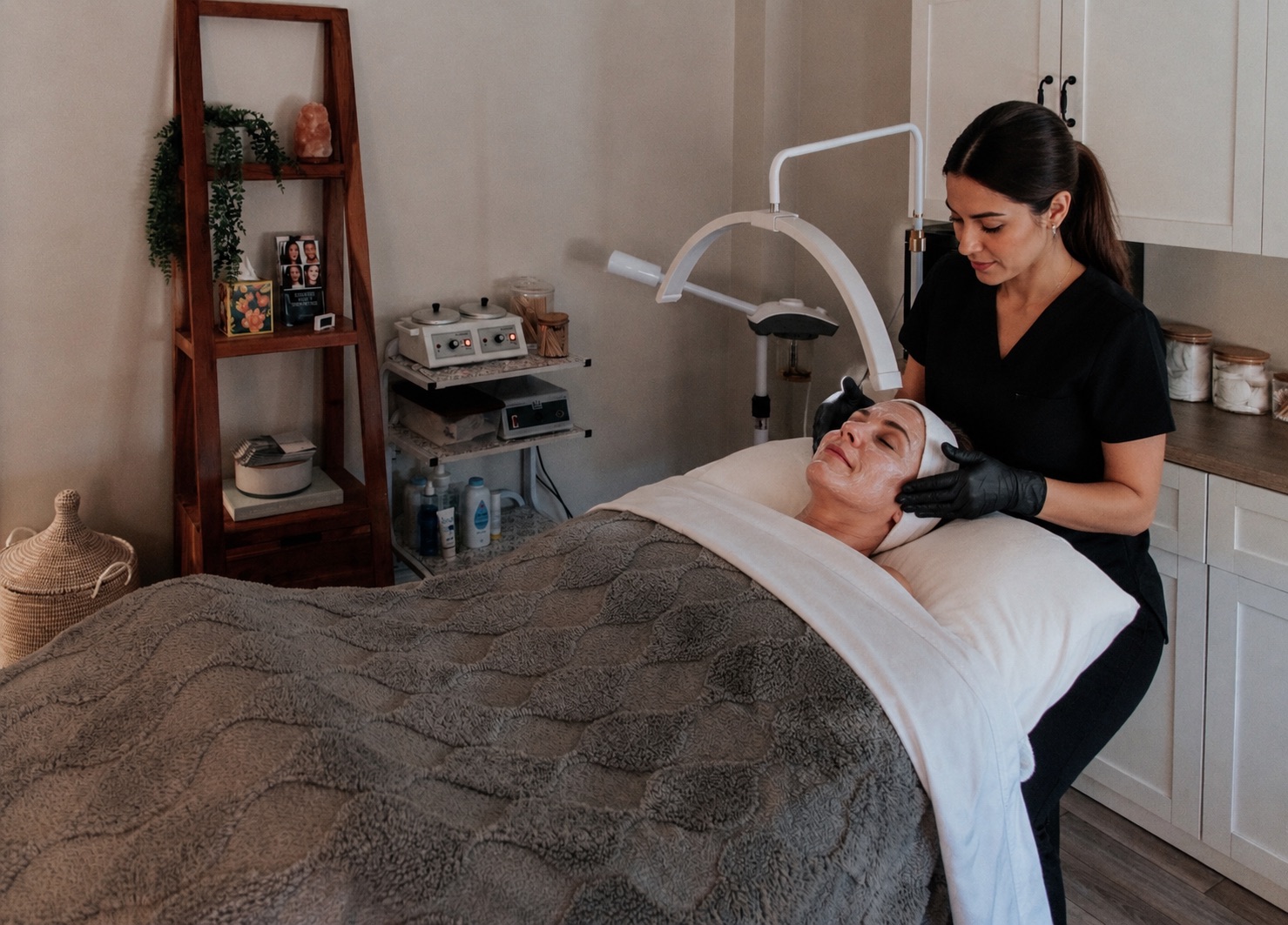 Provider applying a facial treatment to a client at Thrive Med Spa