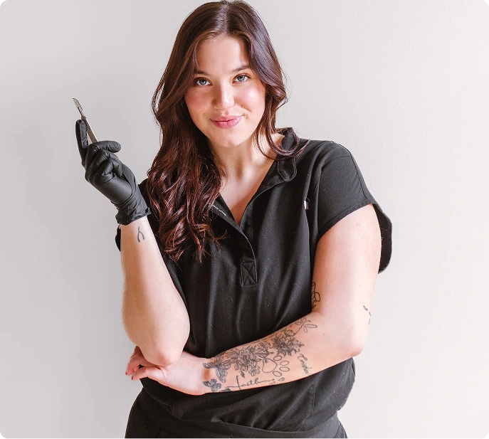 Professional holding a laser treatment device against a neutral background