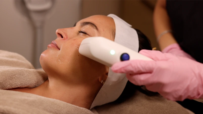 Clinician performing Sofwave treatment on patient's face at Treat Medspa