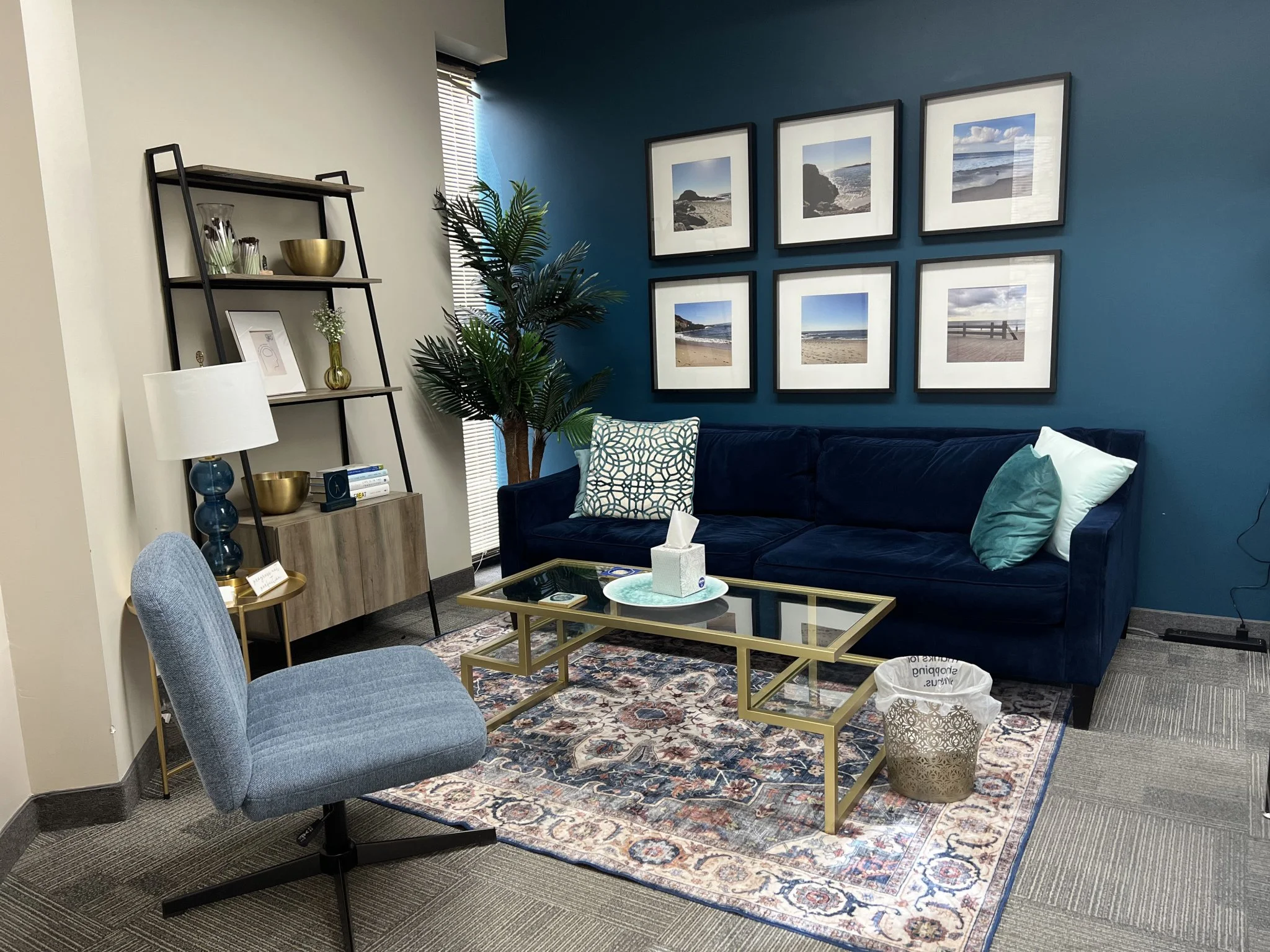 Calm therapy room at Wiser Counseling with a navy sofa and soft lighting
