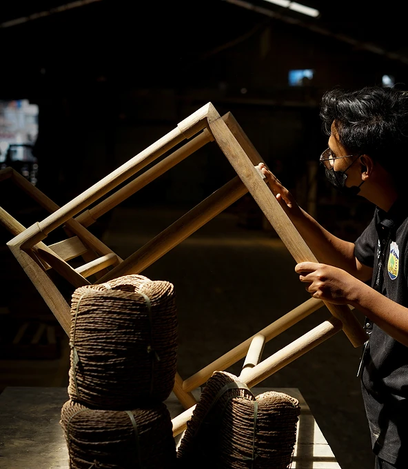 Artisan assembling a woven frame
