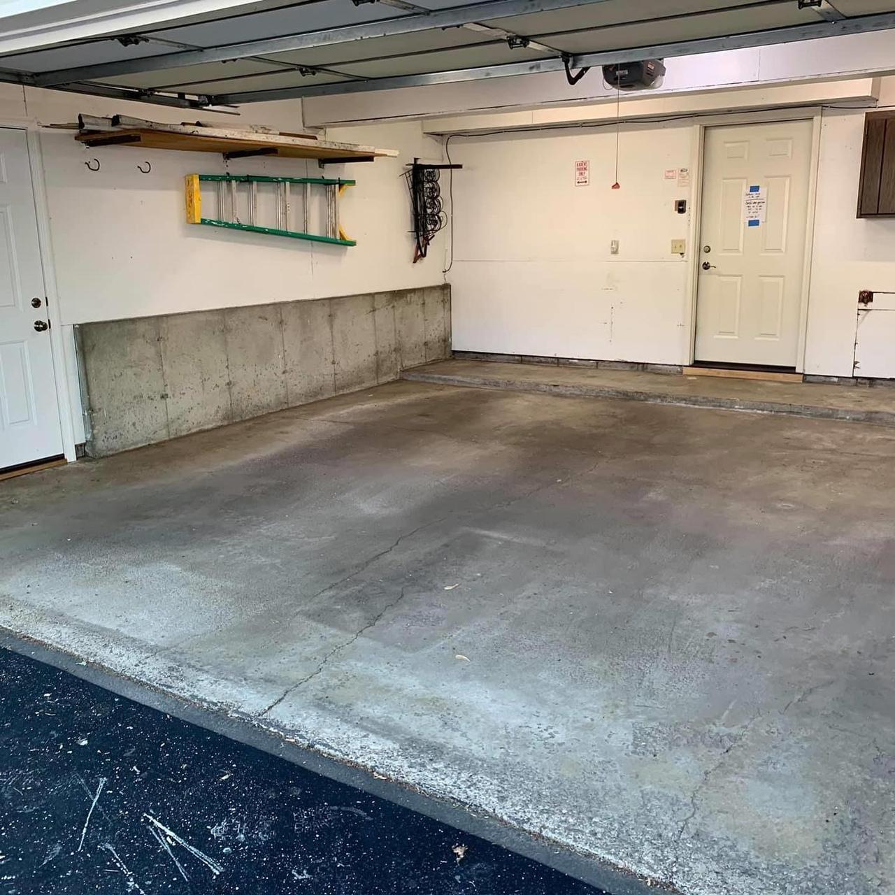 Two-car garage with bare, stained concrete