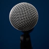 Audio microphone on blue background