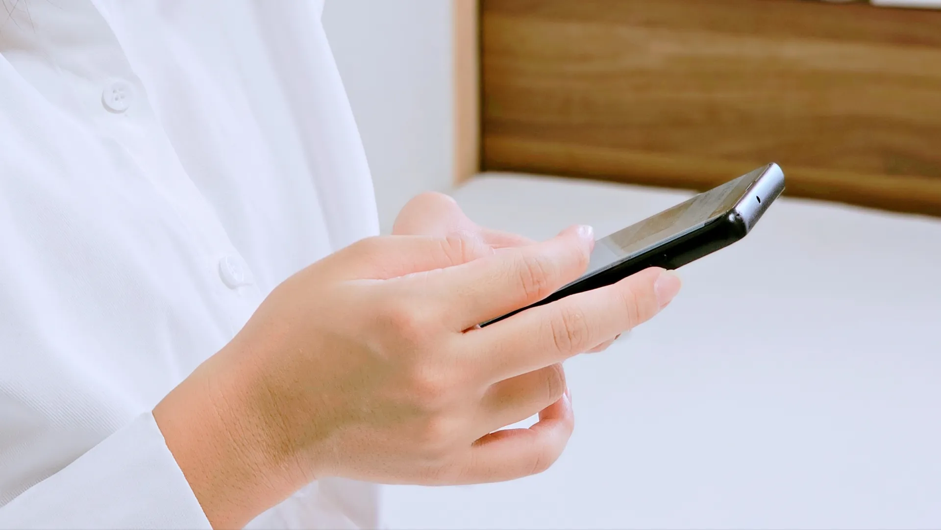 Hands operating a smartphone