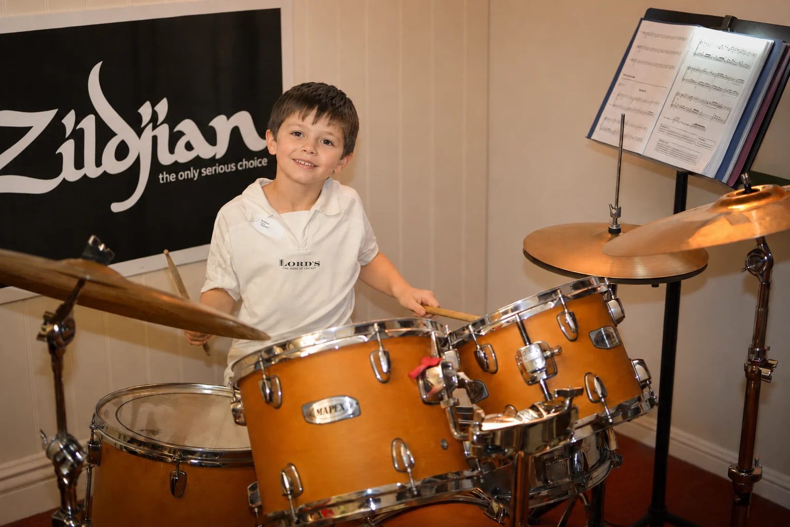 A child playing drums during a lesson at Planet drum