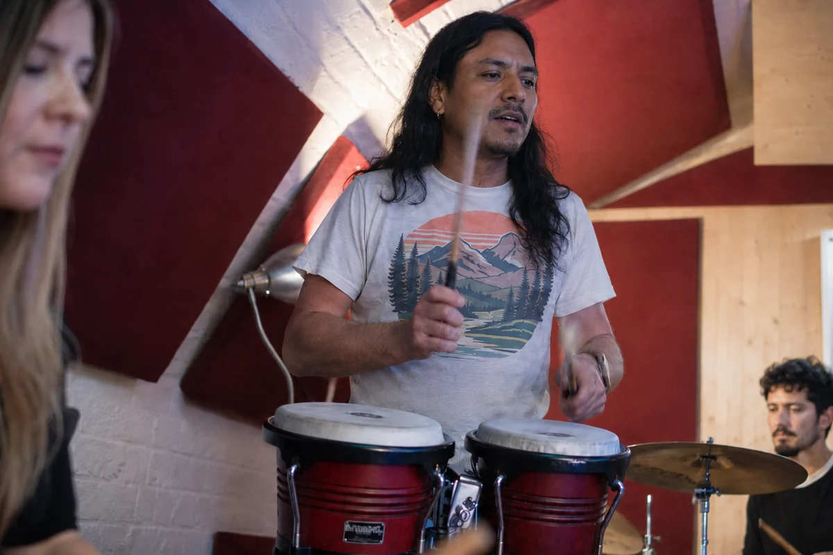 Team members playing percussion together in Planet drum's Crypt studio