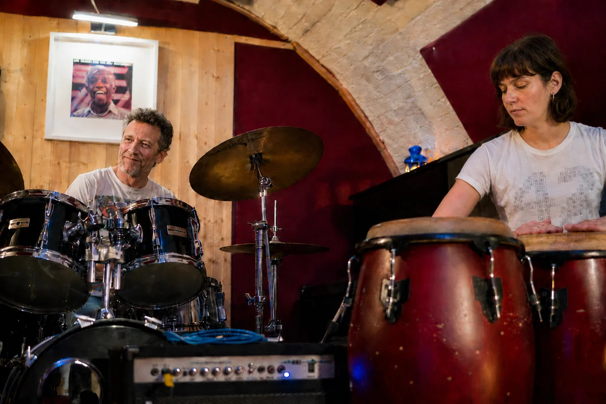 Drum kit and congas being played together in a jam session at Planet drum