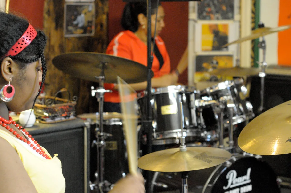 Two adults sharing a music lesson at Planet drum, Shared membership