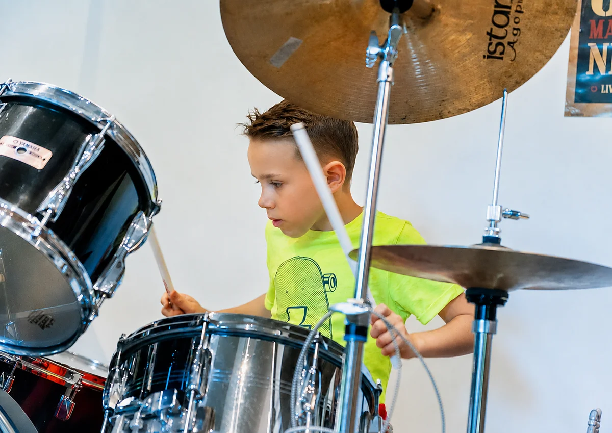 Child taking a 25-minute drum lesson with a Planet drum tutor