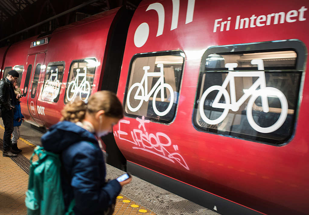 People stand in front of a train with a bicycle Compartment. © Chris Grodotzki / Greenpeace