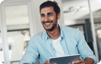 Man holding a tablet, smiling and looking forward