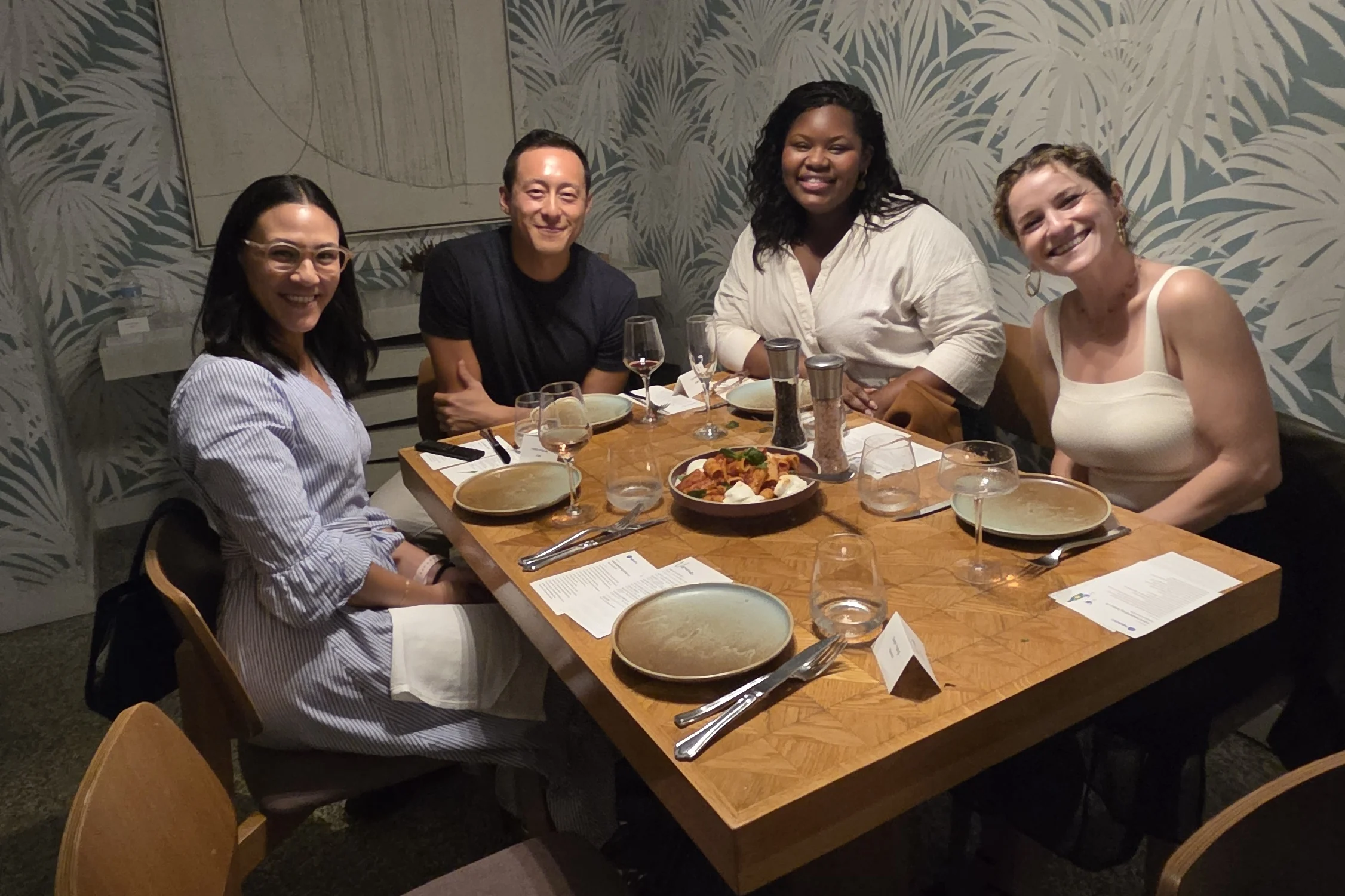 Salon guests smiling around a dinner table at Viviane in Beverly Hills