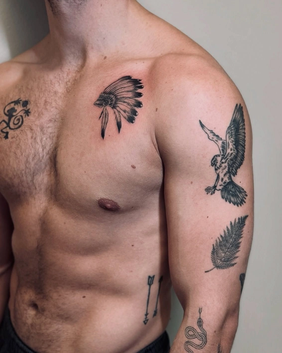 Patchwork blackwork Native American, eagle, arrow tattoo idea for men on chest and arm.