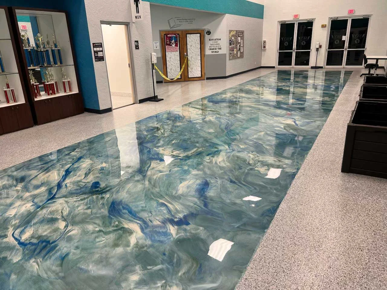 Metallic epoxy swirl floor in a school lobby