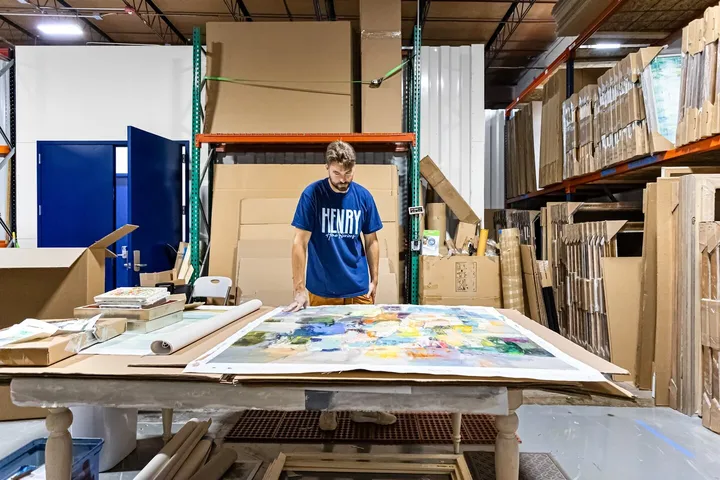 Artist working on a large piece inside a WareSpace production studio