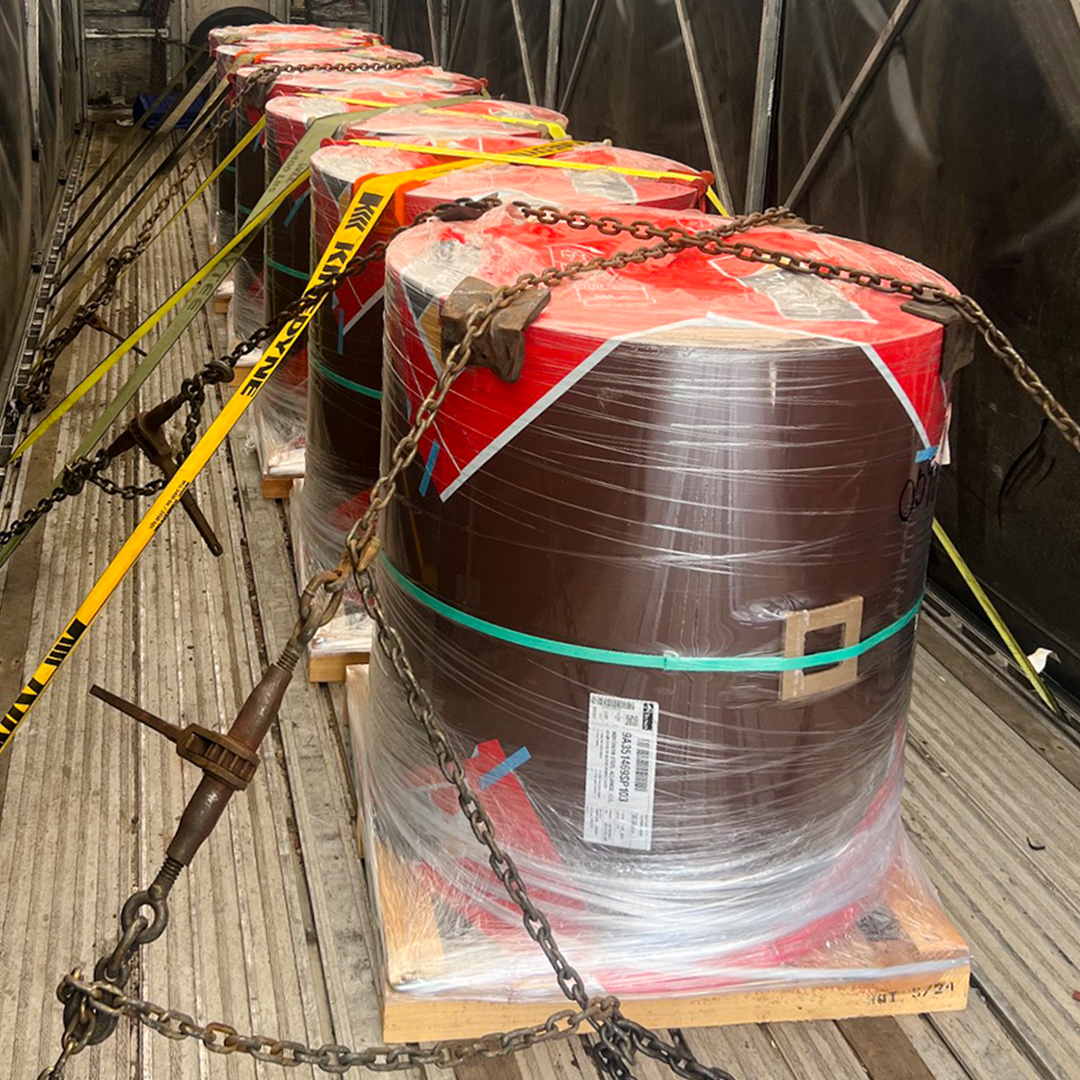 Coated steel coils chained and secured on a flatbed deck