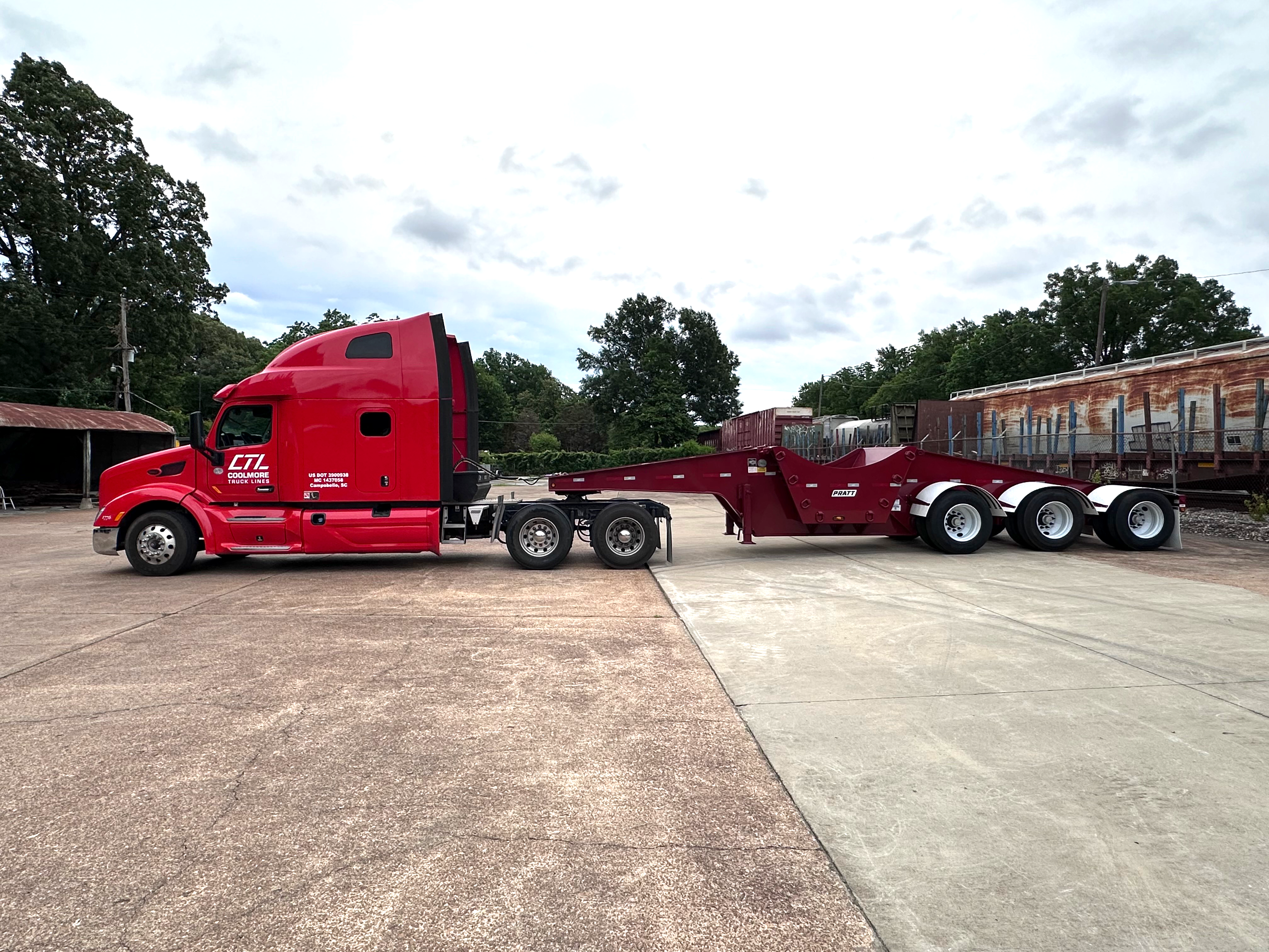 Coolmore Truck Lines red Peterbilt coupled to a PRATT removable-gooseneck lowboy