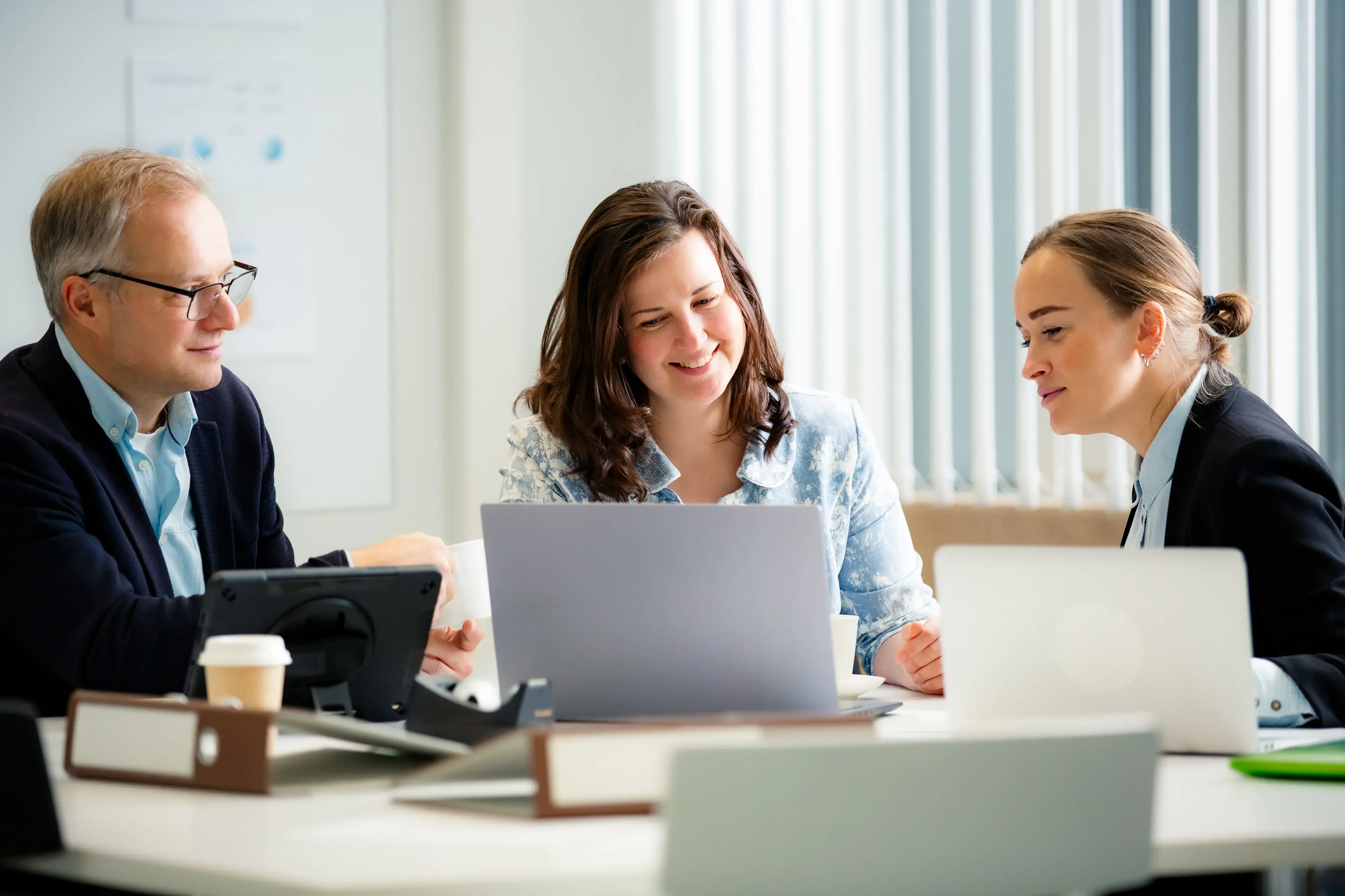 A small team working together around a laptop