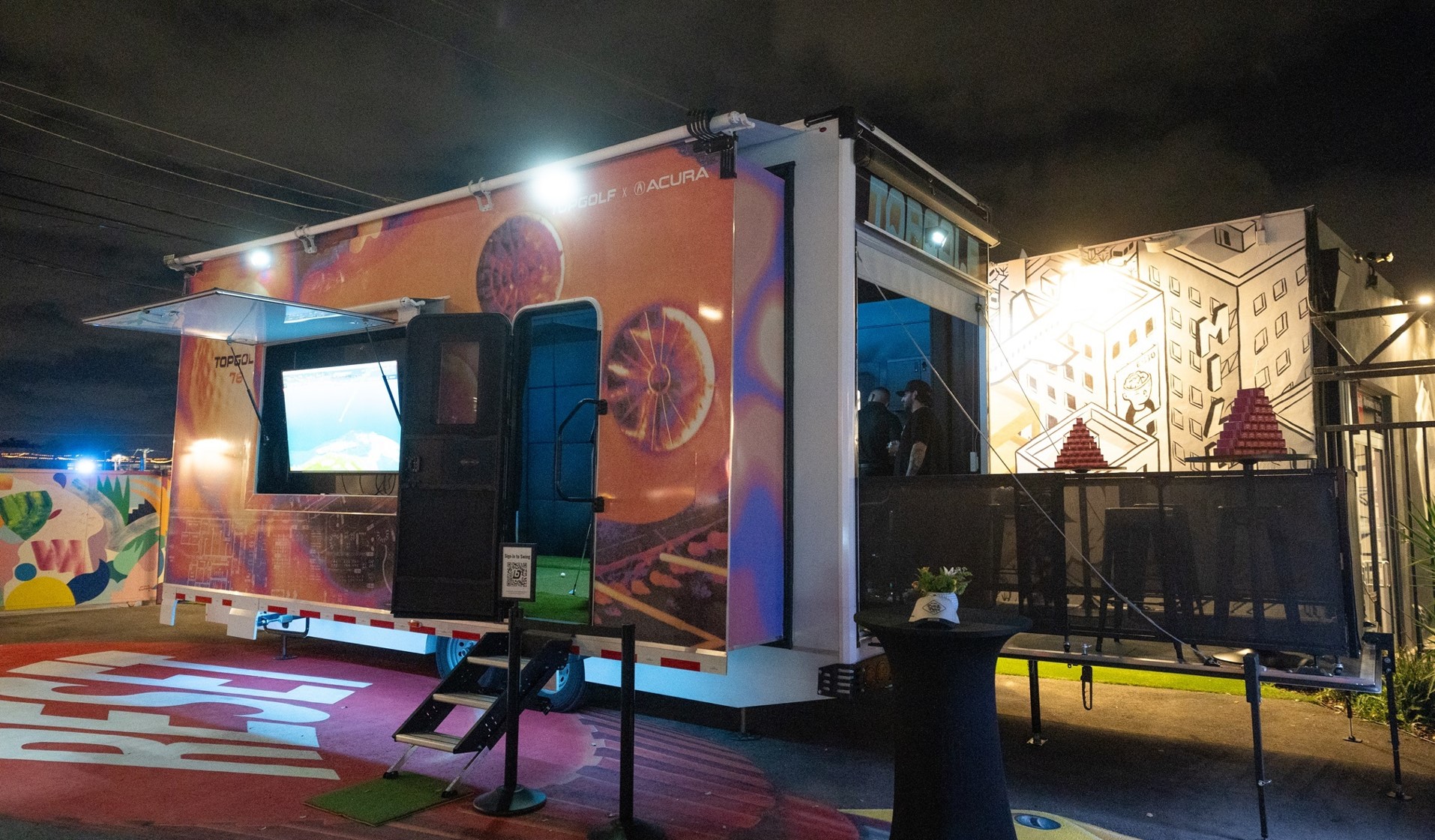Topgolf x Acura-wrapped Dryvebox trailer activated at Art Basel Miami at night
