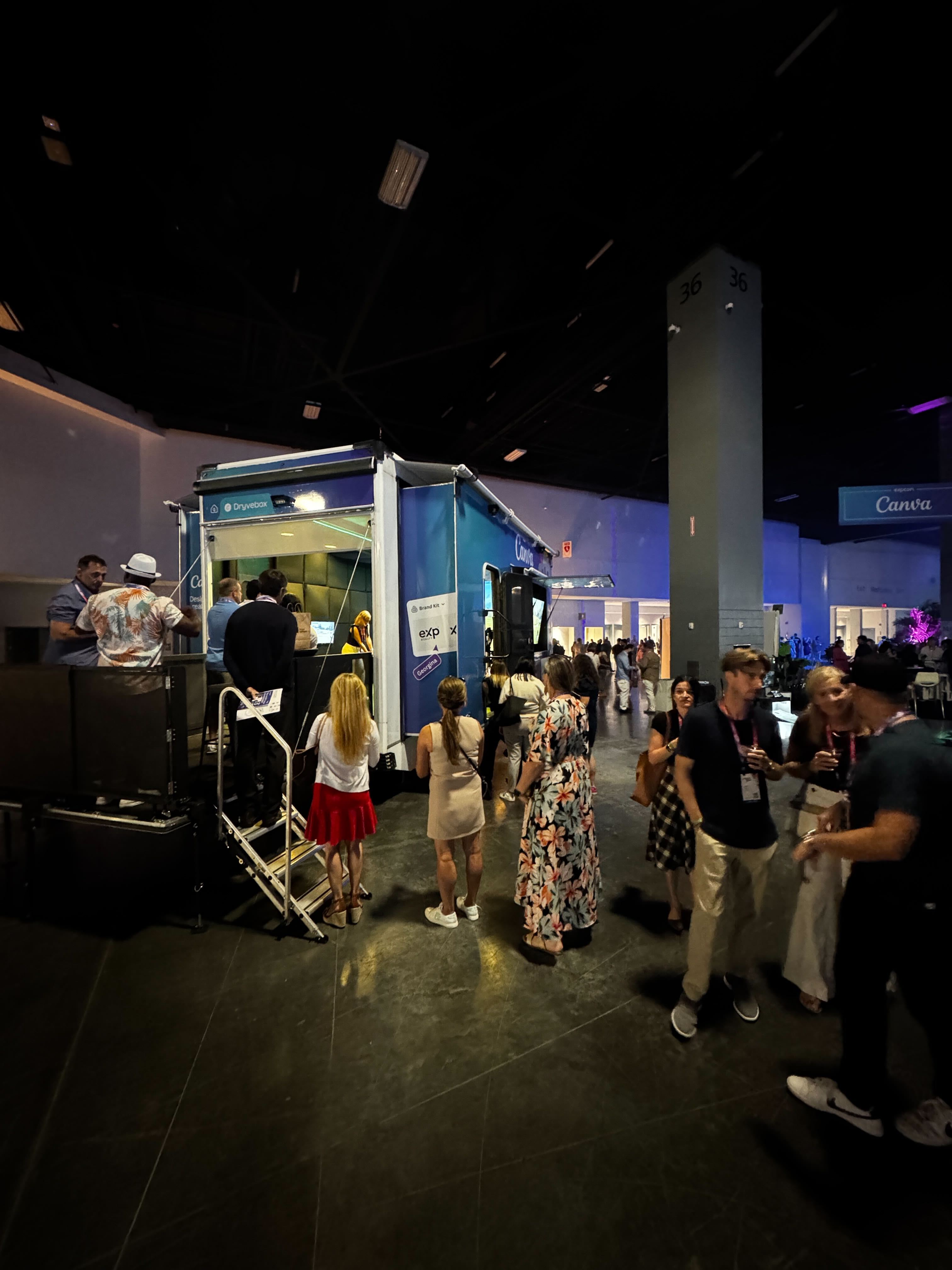Dryvebox trailer wrapped for Canva ExpCon with branded blue Canva graphics and attendees lined up to play at booth 36