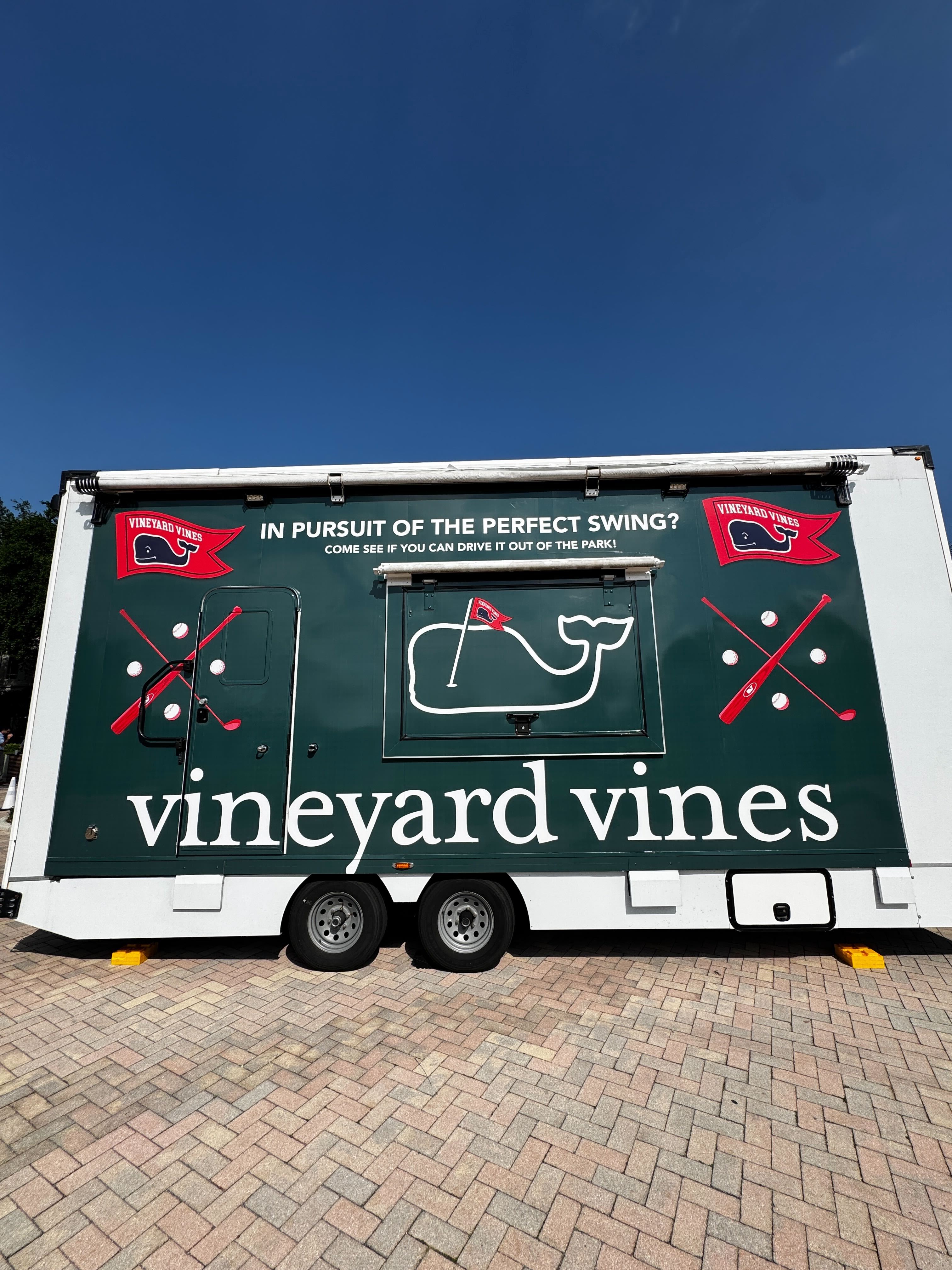 Vineyard Vines Dryvebox trailer wrapped in the brand's signature whale graphics with In Pursuit of the Perfect Swing tagline