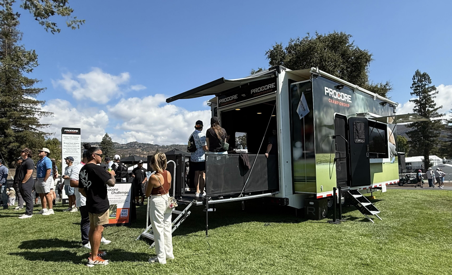 Procore Championship-branded Dryvebox trailer on-course at the PGA TOUR event in Napa with fans queued up