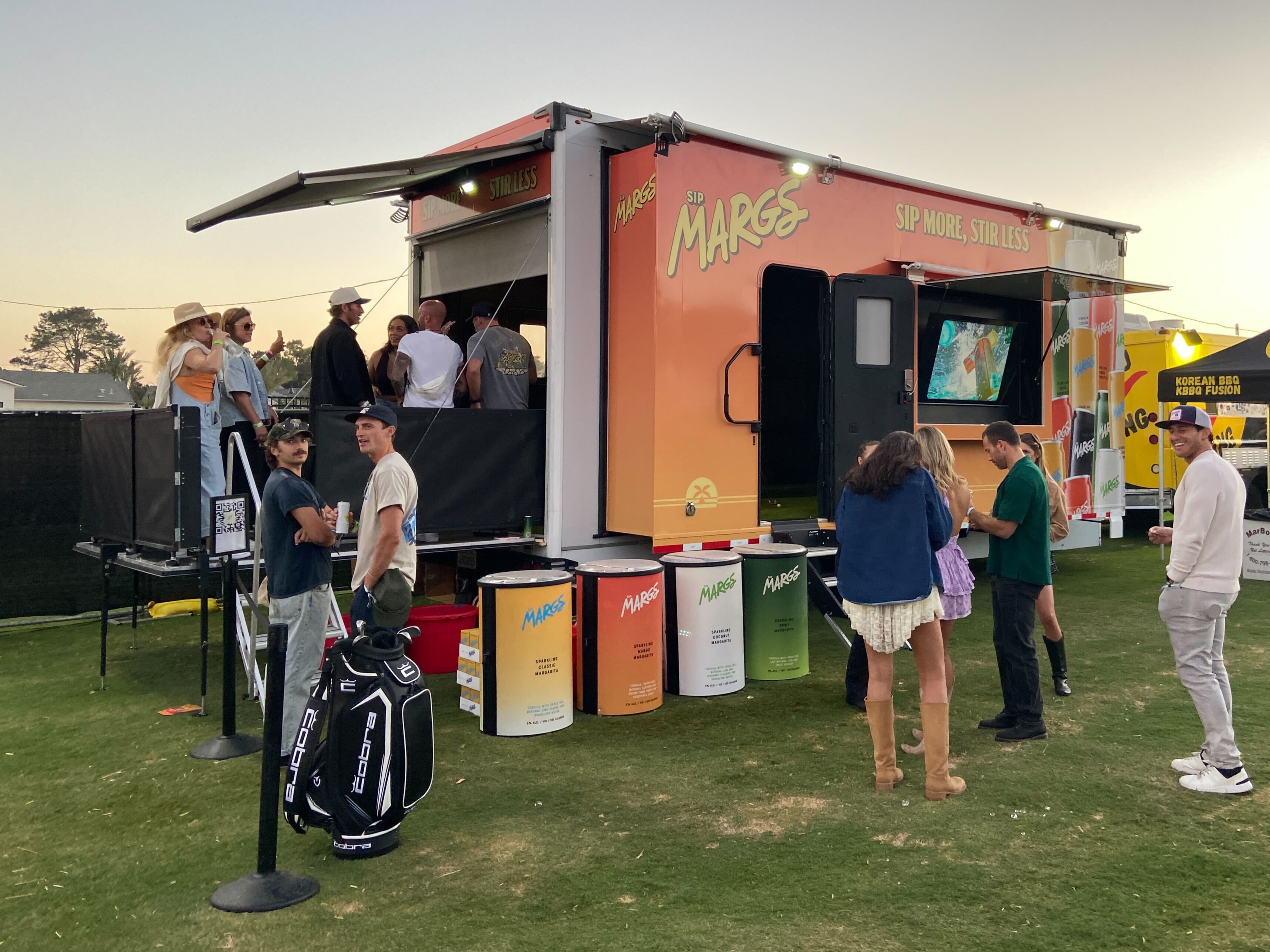 Sip Margs × Palm Tree Crew Dryvebox trailer at golden hour with guests gathering for cocktails at the Montecito activation