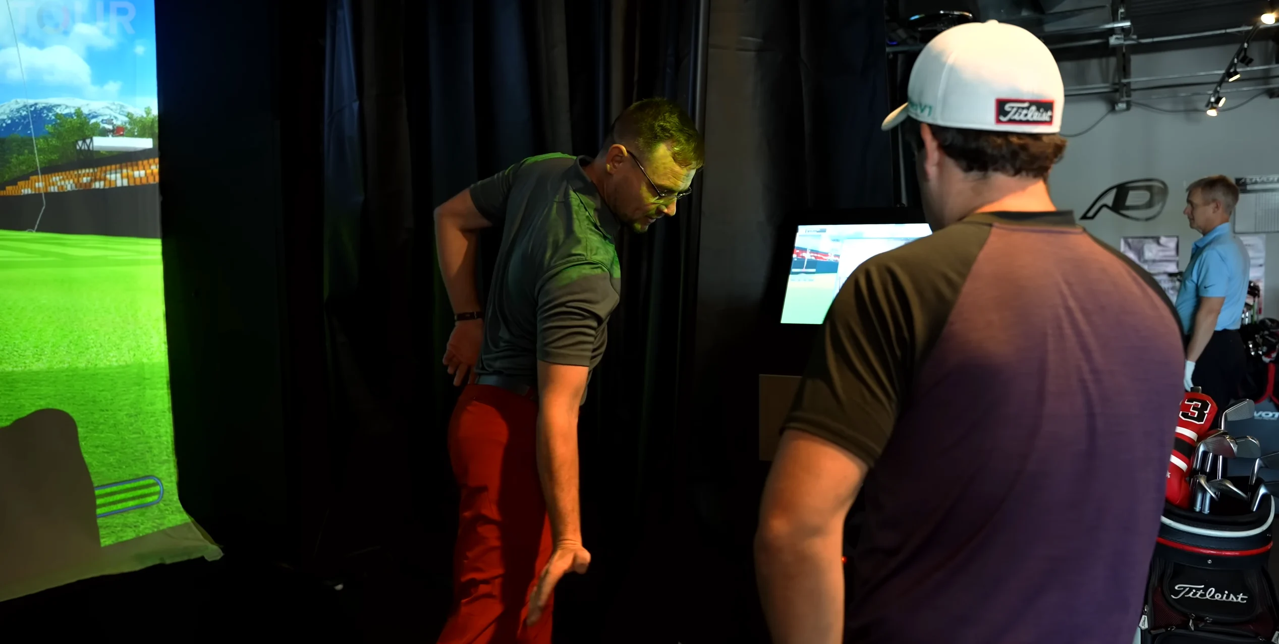 Zac Treash demonstrating a golf movement during an indoor lesson