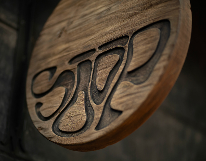 Sōōp ramen bar identity — hand-carved wooden logo medallion