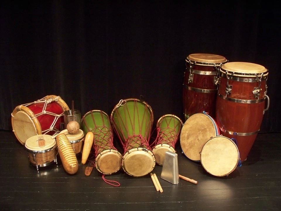 Afro-Caribbean percussion — bomba drums, congas, panderetas and güiro on a museum stage