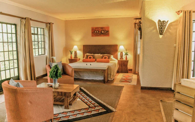 A warm guest bedroom at Wilderness Sabyinyo