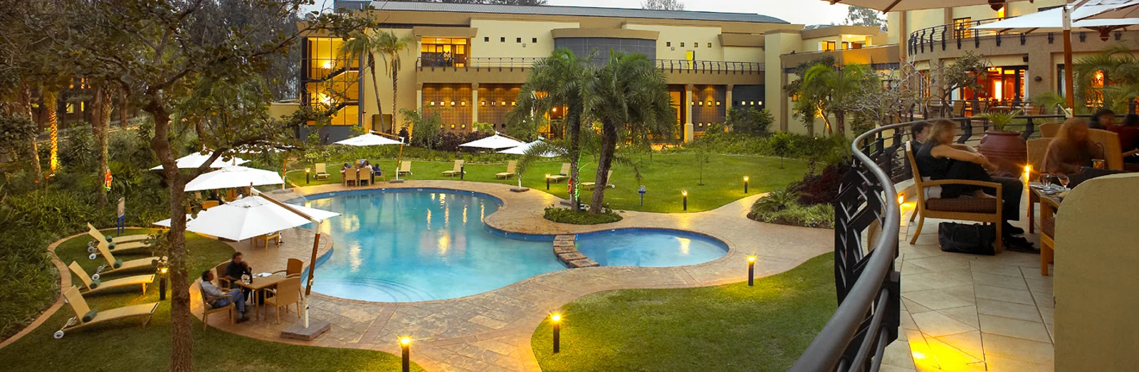 The illuminated pool and courtyard at Kigali Serena Hotel