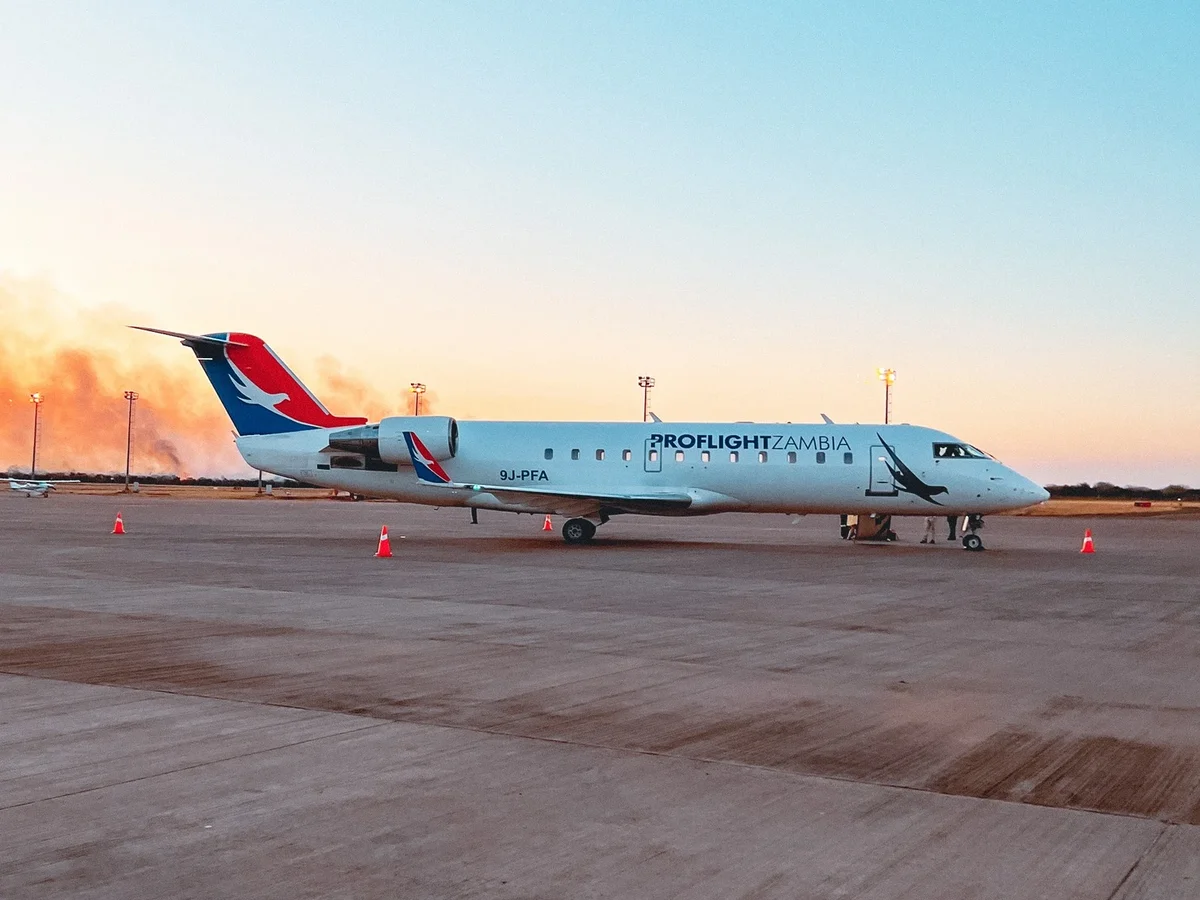 Proflight Zambia aircraft on the airport ramp, illustrating the flight to Lusaka