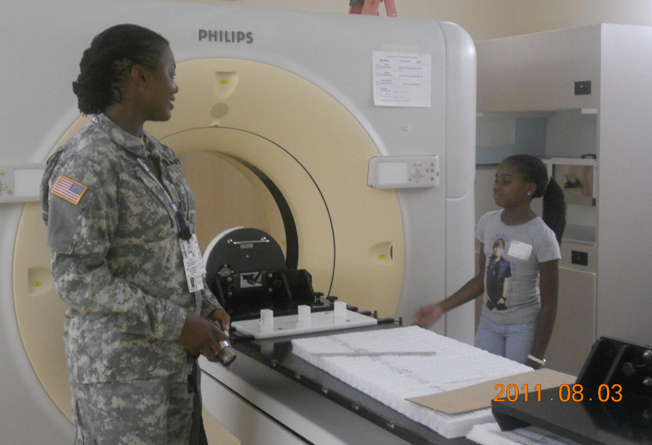 Dr. Williams with students touring a radiation oncology center at summer camp